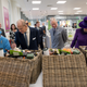 Britain’s Queen Elizabeth II, Prince Philip, Duke of Edinburgh, Prince Charles, Prince of Wales and Camilla, Duchess of Cornwall look at food hampers during a visit to a Waitrose supermarket in the town on October 27, 2016 in Poundbury, England. Photo via Getty Images.